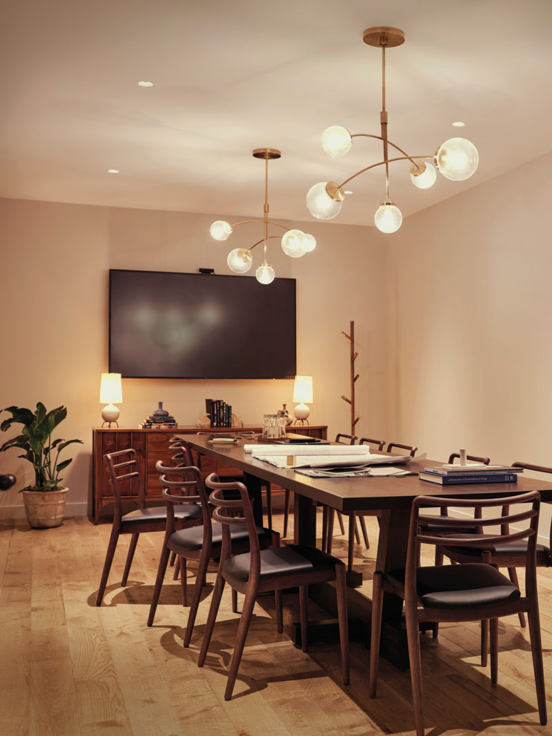 Empty meeting room with 8 chairs around a table and TV on the wall