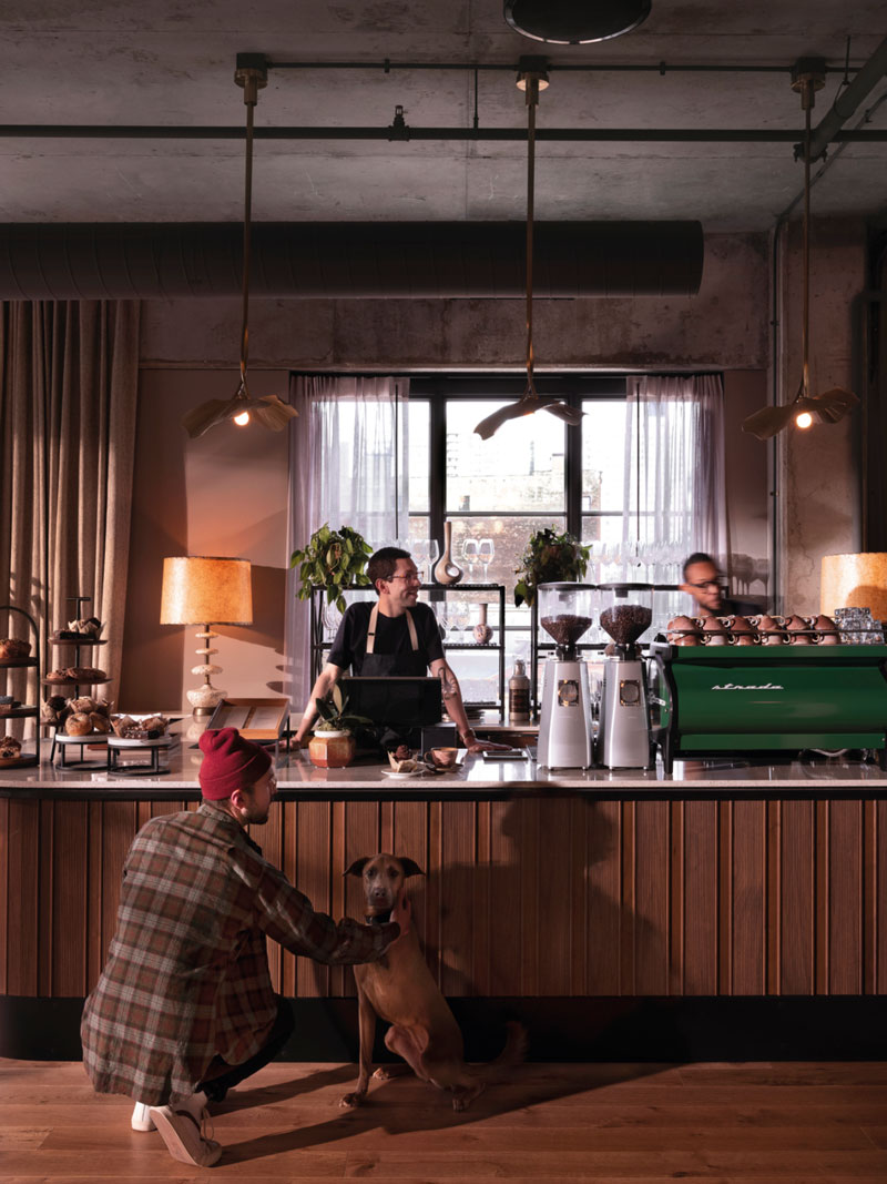 A member with his dog are served at the coffee bar