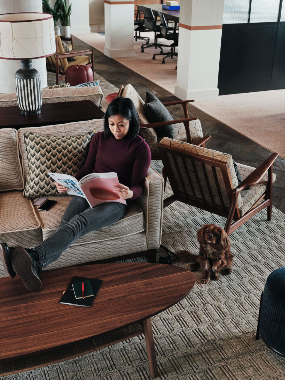 Girl sitting on sofa reading a magazine