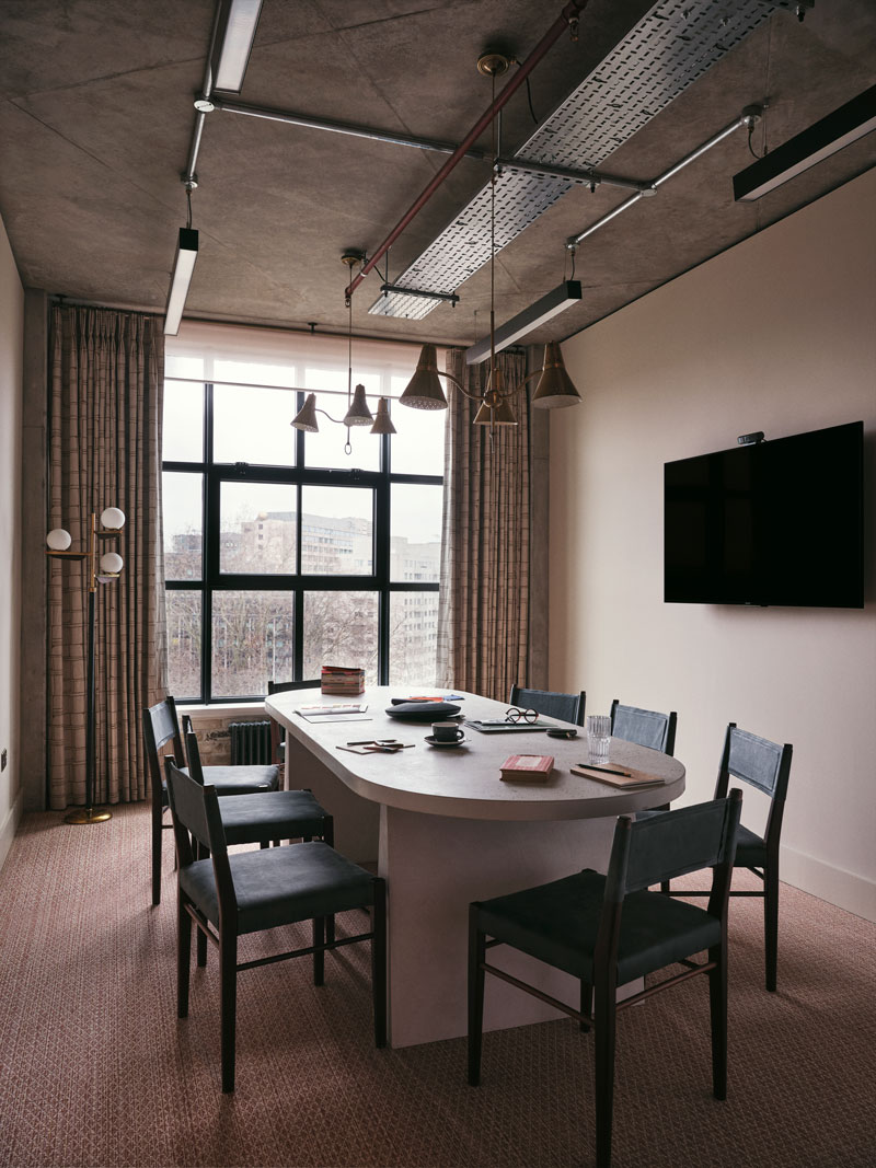 Empty meeting room with six seats around a desk