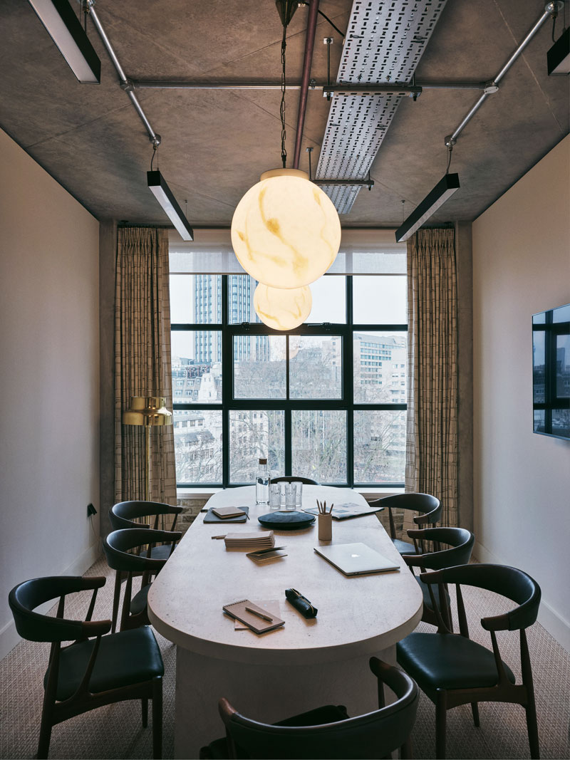 Empty meeting room with six seats around a desk
