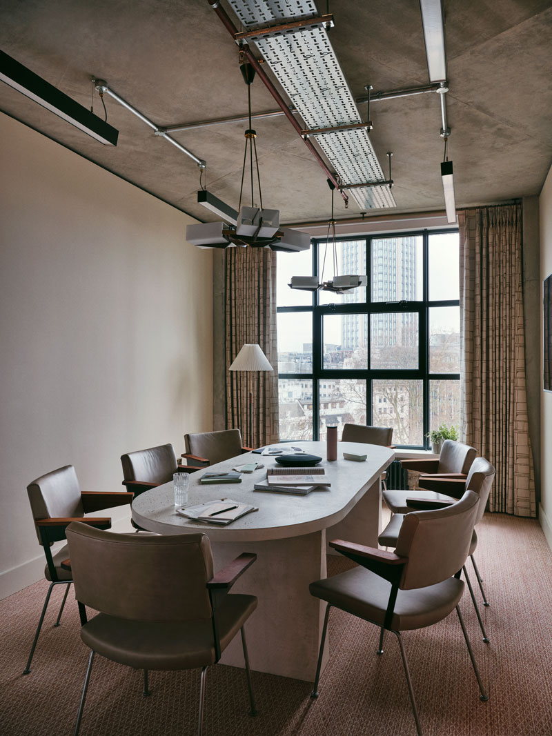 Empty meeting room with six seats around a desk