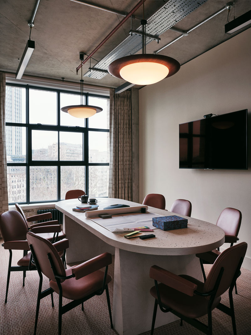 Empty meeting room with six seats around a desk