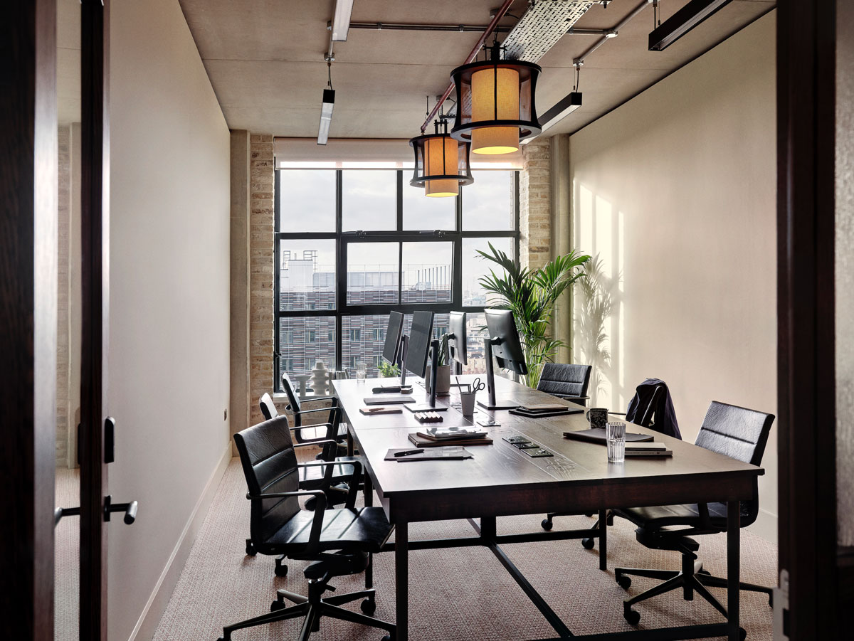 Six person private studio with large plant in the corner