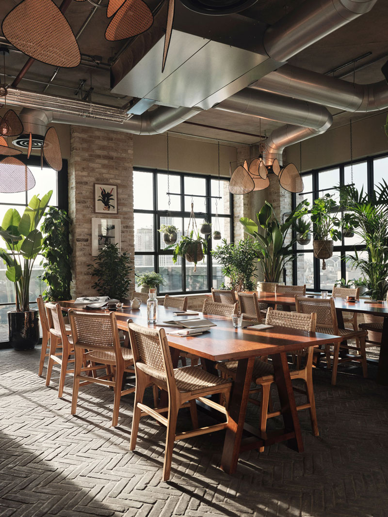 Desks and chairs surrounded by plants in the Winter Garden