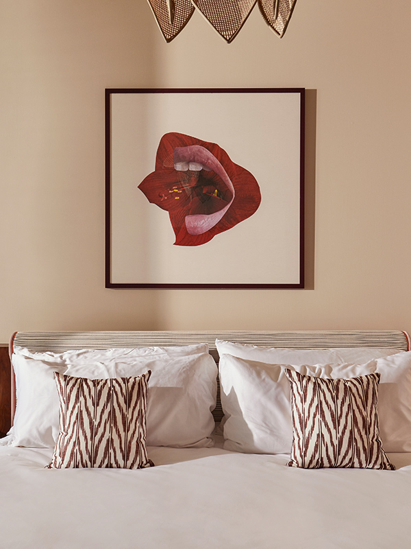 Bedroom at The Hoxton Brussels with plump pillows and artwork above the bed