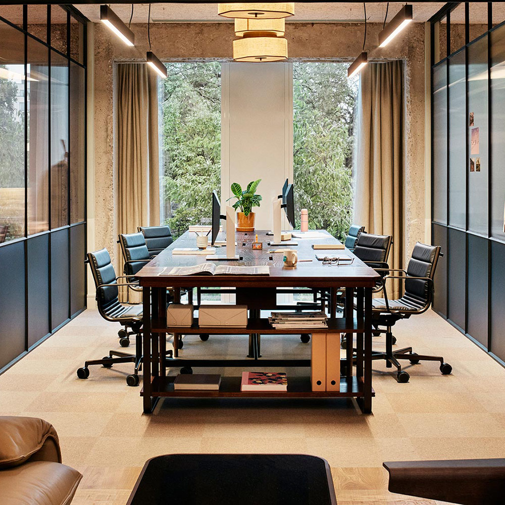 Studio with desks, chairs and open window behind