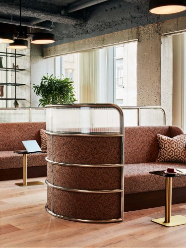 A day bed with a private screen and a table in front.